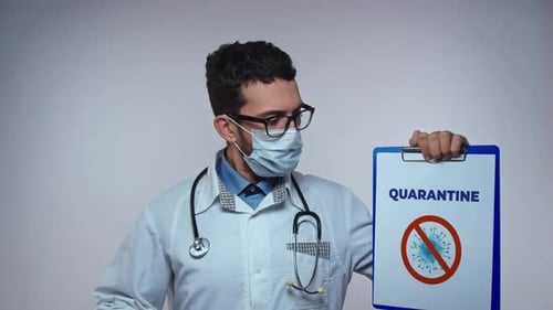 The Doctor in a Mask and Gloves Holds a Form with the Inscription Quarantine