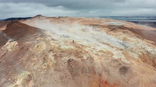 Person Walks in Geothermal Landscape Aerial View