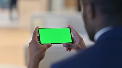 Young Adult Holding Phone with Green Screen