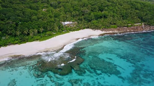 Aerial Footage of Tropical Beach with White Sand Beach and Crystal Clear Water and Coral Reef at