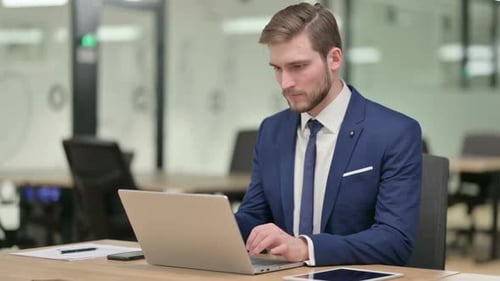 Young Adult Man Cheering at Work in Office