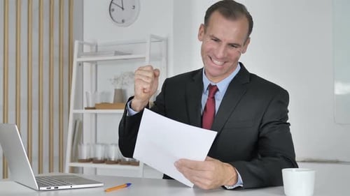 Businessman Excited Reading Good News at Work