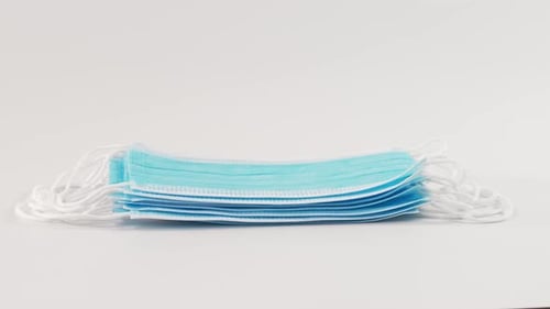 Gloved Hand Stacking Medical Face Masks