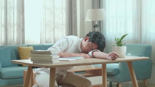 Asian Man Student Sleeping While Studying At Home