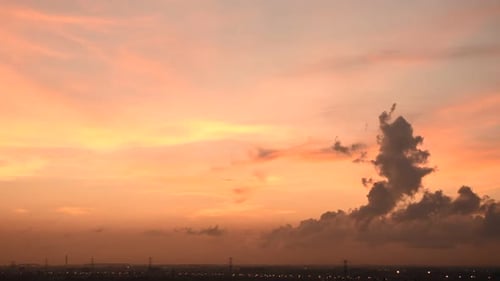 Golden Sunrise Over Cityscape with Vibrant Clouds