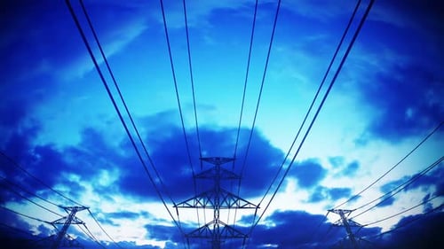 Dynamic Fly-Through Power Lines and Electricity Pylons Against Blue Sky