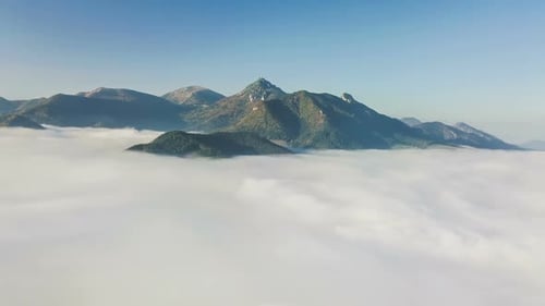 Aerial View of Mountain Peaks Emerging from Fog