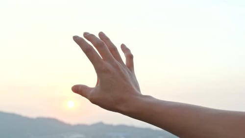 Hand to sun