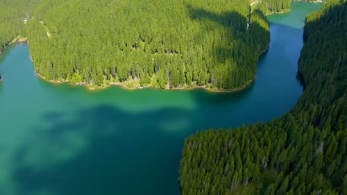 Mountain lake with turquoise water and green trees. Reflection in the water.