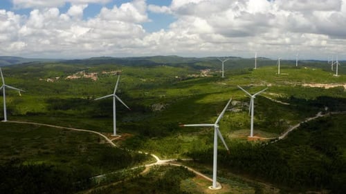 Wind generator rotate on mountain ridge.