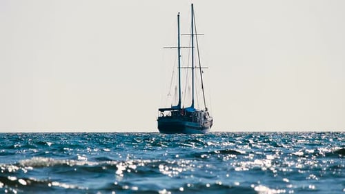 Sailing Vessel on Calm Sparkling Ocean