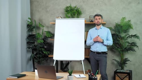 Man Presenting at Whiteboard in Modern Office Setting