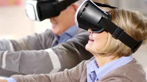 Senior Couple Enjoys Virtual Reality Experience with Goggles
