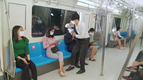 Masked Commuters ride Urban Public Transportation