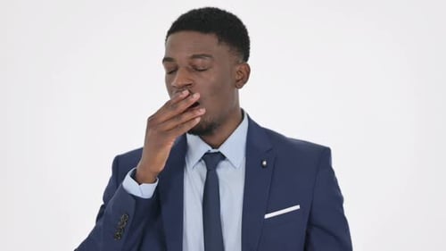 African Businessman Yawning on White Background