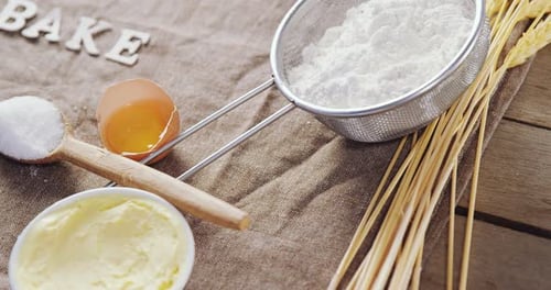 Baking Ingredients Arranged Overhead with Flour, Egg, and Butter