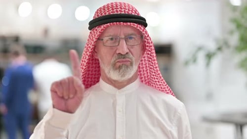 Man in Headscarf Raising Index Finger