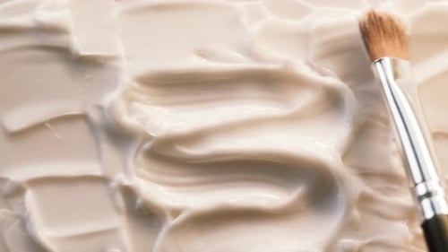 Smearing Cream on White Background Using Brush