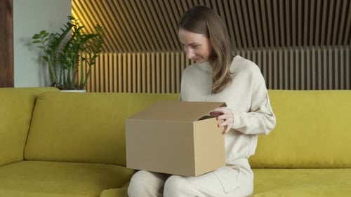 Woman Opening Box with a Surprised Smile