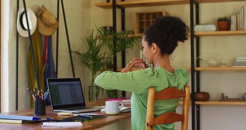 Woman Stretching While Working at Home Office