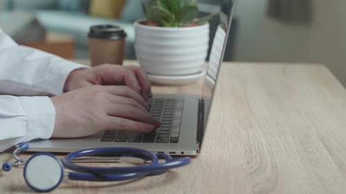 Hands Male Doctor Typing On Laptop Computer At Home Office