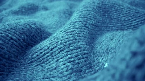 Extreme detail view of sheep wool cloth texture flowing in macro dolly shot.