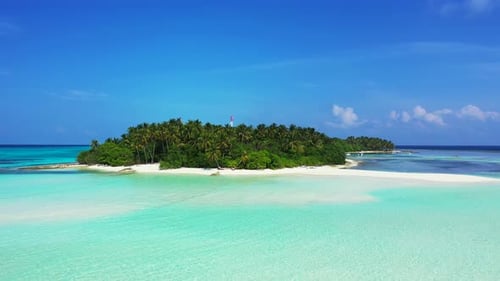 Wide angle flying travel shot of a sandy white paradise beach and aqua turquoise water background