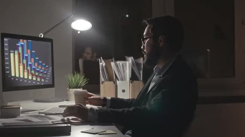 Man Making Financial Report at Night