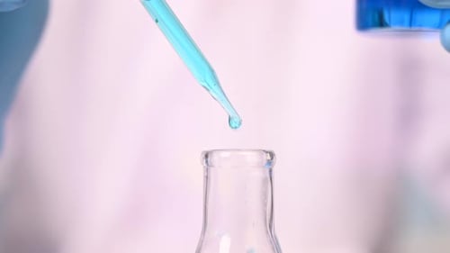 Scientist Drops Blue Liquid into Flask