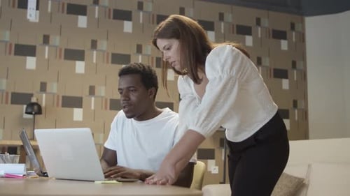 Teamwork in Office: Collaborating on Laptop Together