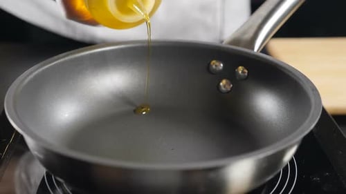 Cooking Oil Being Poured Into a Frying Pan