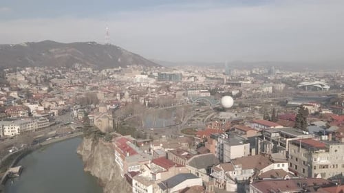 Aerial view of Metekhi church in old Tbilisi located on cliff near river Kura. Georgia 2021 winter