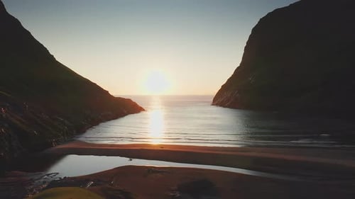 Aerial View of Sunset on the Beach with Awesome Sun Golden Reflection on Calm Waves