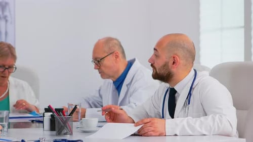 Medical Team Meeting at Conference Table