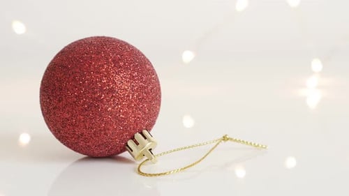 Red shiny bauble with sequins close-up 4K 2160p 30fps UltraHD footage - Christmas ornament and fair
