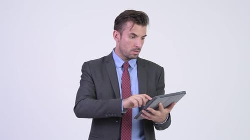 Businessman Using Tablet with Varied Reactions