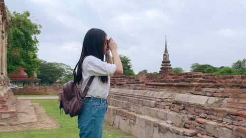 Japanese backpacker female enjoy her journey at amazing landmark in traditional city.