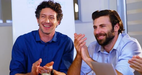 Business Team Clapping During a Meeting at Work