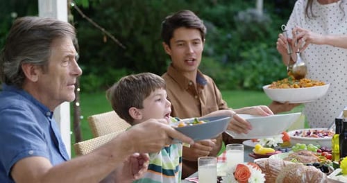 Family Meal Outside in Garden on Sunny Day