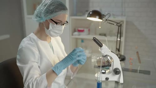 Medical Researcher Mixing Fluid Samples in Laboratory