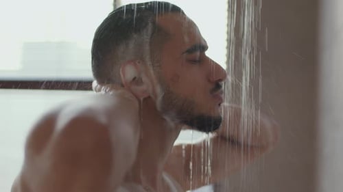 Man Washing Hair with Shampoo in Shower