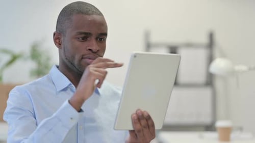 Man Using Tablet in Office Workplace Setting