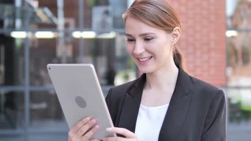 Smiling Woman on Tablet Video Call Outdoors
