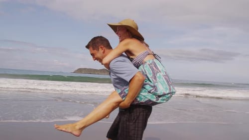 Playful couple at beach having fun, Costa Rica. Shot on RED EPIC for high quality 4K, UHD, Ultra HD