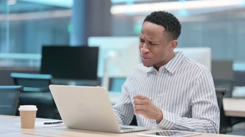 Frustrated Man Reacting to Bad News on Laptop