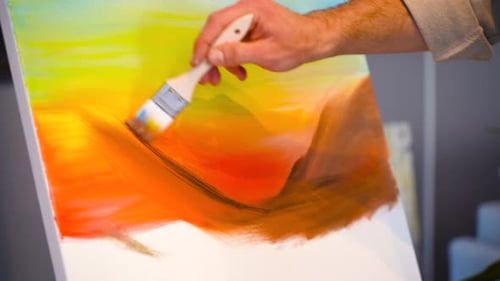 Person Painting on Canvas with Brush