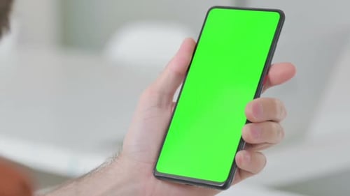 Close Up of Young Man Using Smartphone with Green Screen