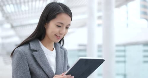 Woman Using Tablet Device in Modern Urban Setting