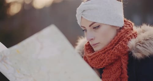 Woman Looks at Map on Winter Day