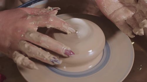 Hands Shaping Clay on Pottery Wheel